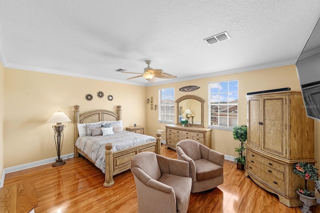 bedroom with a textured ceiling, crown molding, ceiling fan, and light hardwood / wood-style flooring