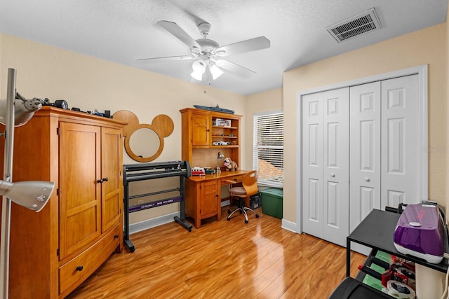 office area featuring ceiling fan, a textured ceiling, and light wood-type flooring