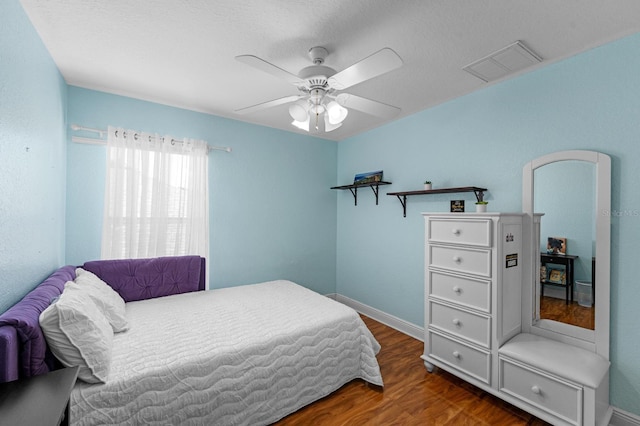 bedroom with ceiling fan and dark hardwood / wood-style flooring