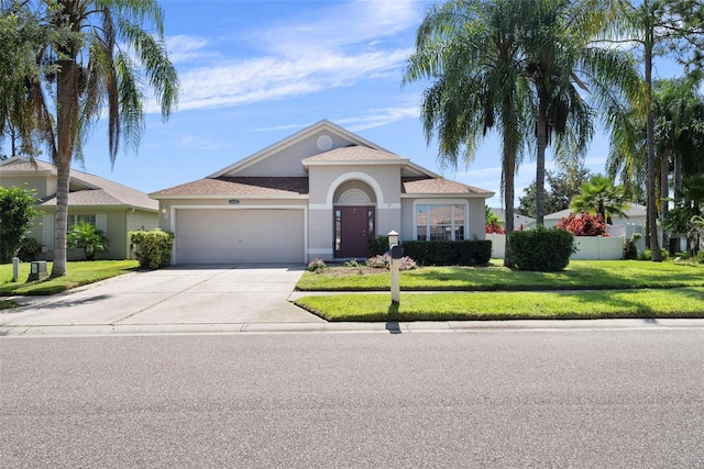 ranch-style home featuring a front yard and a garage