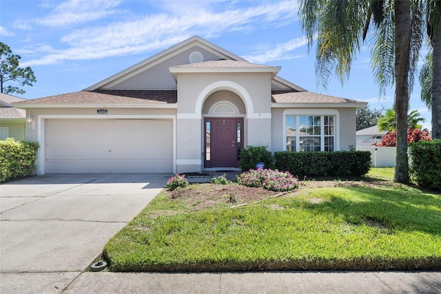 ranch-style home with a garage and a front lawn