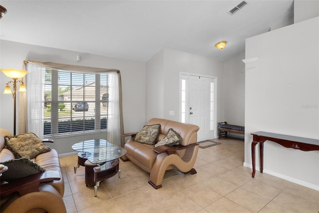 tiled living room featuring vaulted ceiling