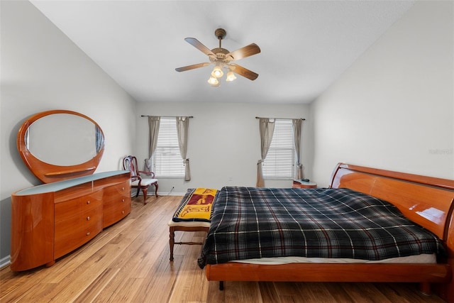 bedroom featuring lofted ceiling, light hardwood / wood-style floors, and ceiling fan