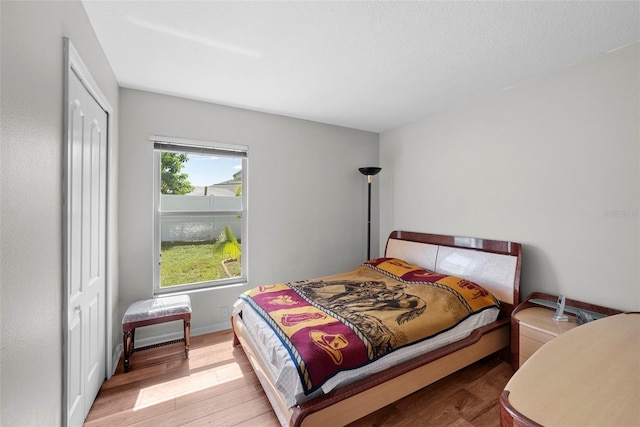 bedroom featuring light wood-type flooring and a closet