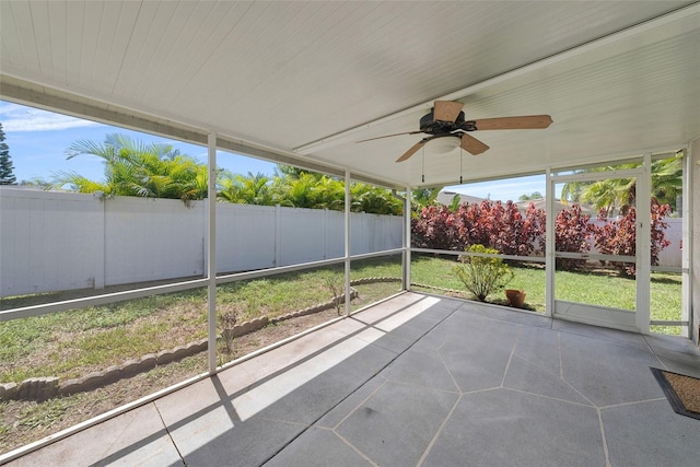 unfurnished sunroom with ceiling fan