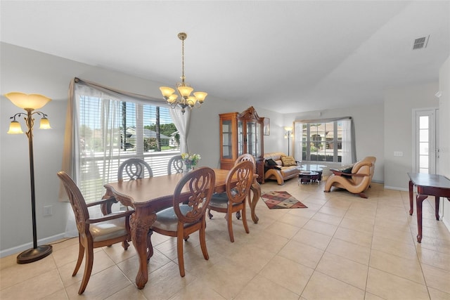 dining room with light tile patterned flooring and a chandelier