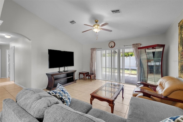 tiled living room featuring ceiling fan and vaulted ceiling