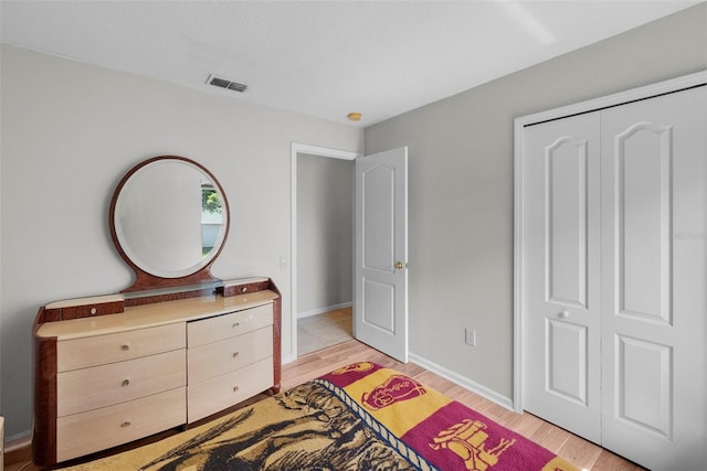 bedroom featuring light hardwood / wood-style flooring and a closet