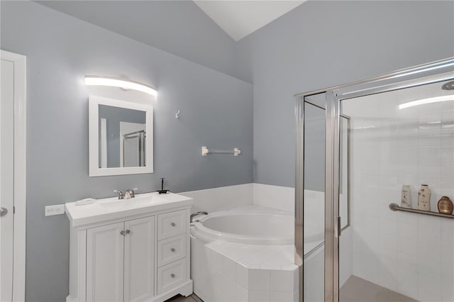 bathroom featuring vaulted ceiling, vanity, independent shower and bath, and tile patterned flooring