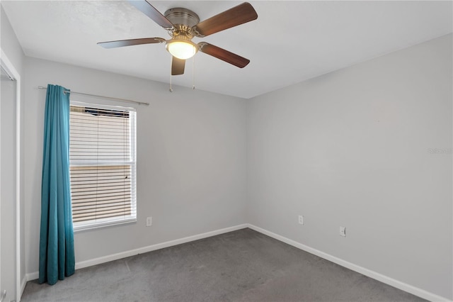 carpeted spare room featuring ceiling fan