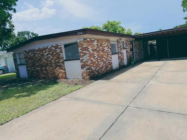 view of side of property with a yard and a carport