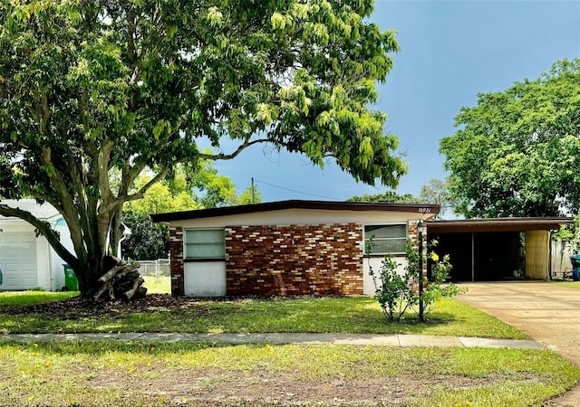 view of side of home featuring a garage and a carport