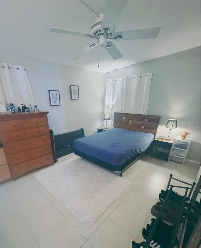 bedroom featuring light tile patterned floors and ceiling fan