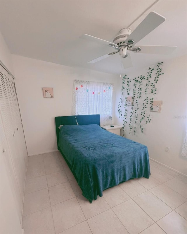 bedroom with a closet, tile patterned flooring, and ceiling fan