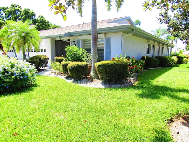 view of side of home featuring a lawn