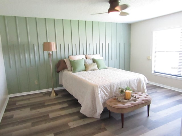 bedroom with ceiling fan and dark hardwood / wood-style floors