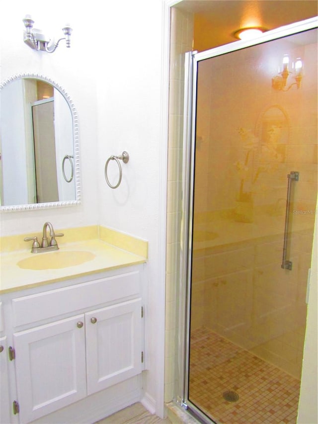 bathroom with walk in shower and vanity