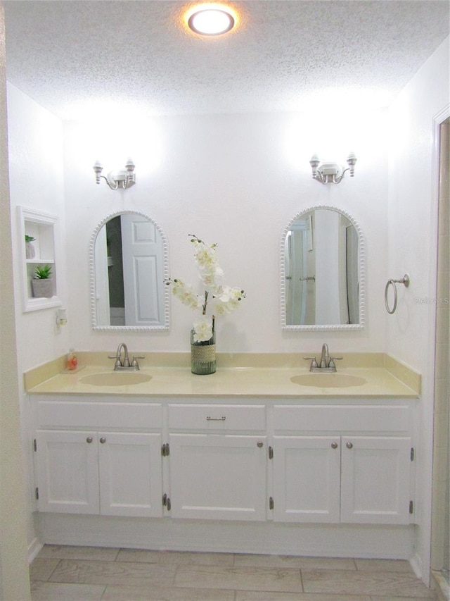 bathroom featuring vanity and a textured ceiling