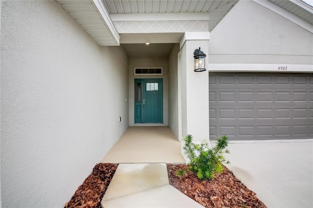 view of exterior entry with a garage