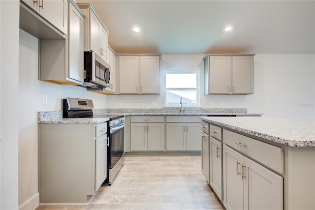 kitchen featuring stainless steel appliances, gray cabinets, and sink