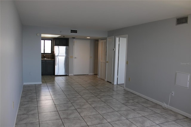 spare room featuring light tile patterned floors