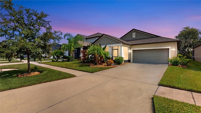 view of front of property featuring a yard and a garage