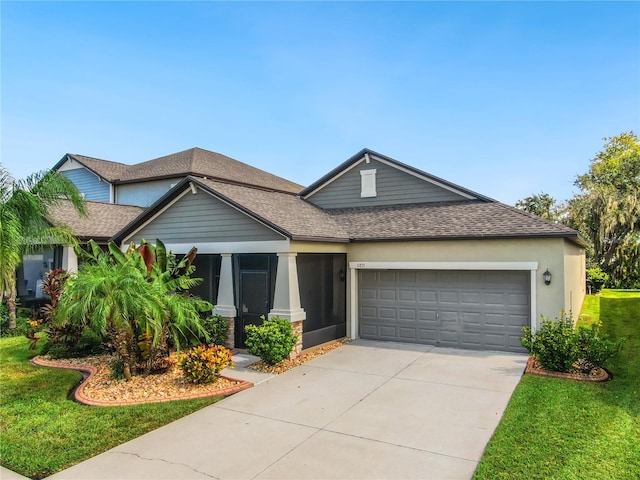 craftsman house with a front yard and a garage