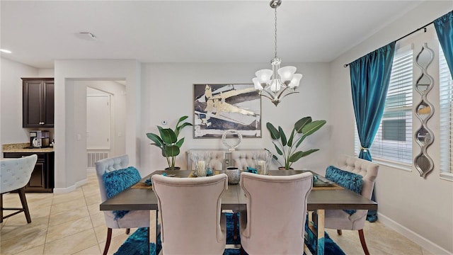 tiled dining space with a notable chandelier