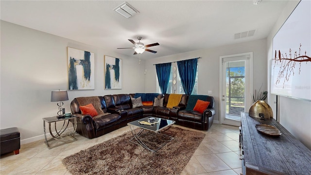 living room featuring light tile patterned floors and ceiling fan