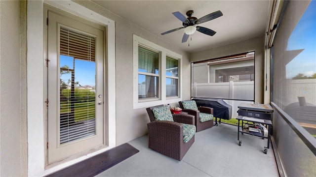 sunroom / solarium featuring ceiling fan