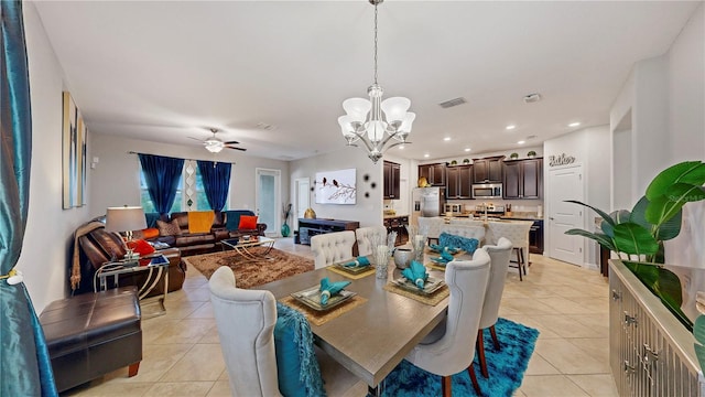 dining room with light tile patterned flooring and ceiling fan with notable chandelier