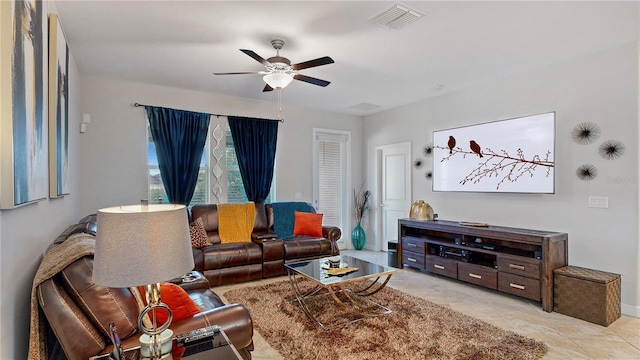 living room with ceiling fan and light tile patterned floors