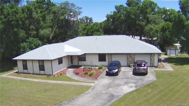 ranch-style home with a garage and a front yard