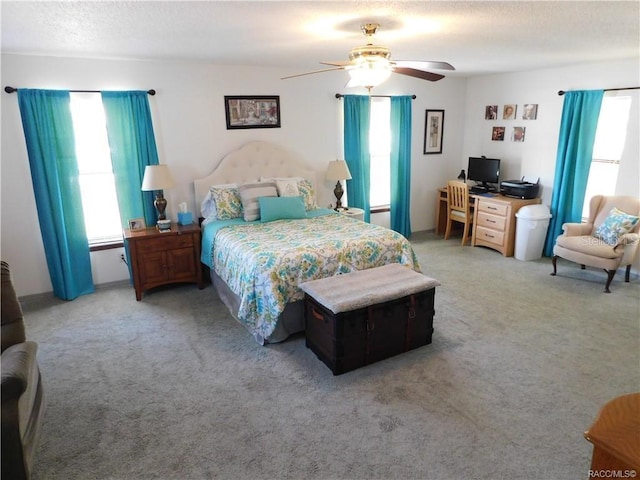 bedroom with ceiling fan and light colored carpet