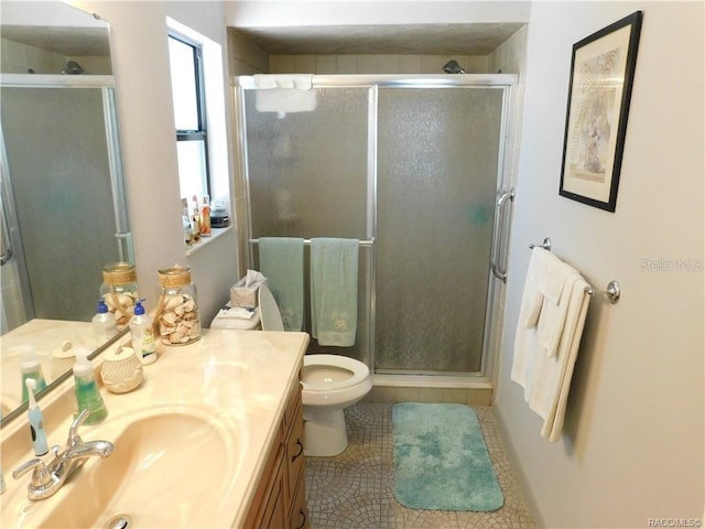 bathroom featuring vanity, tile patterned floors, toilet, and walk in shower