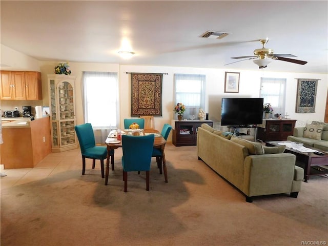 living room featuring a wealth of natural light, ceiling fan, and light tile patterned floors