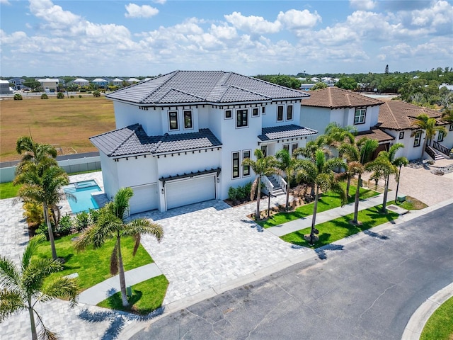 mediterranean / spanish home with a garage