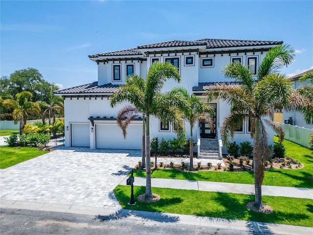 mediterranean / spanish-style house with a garage