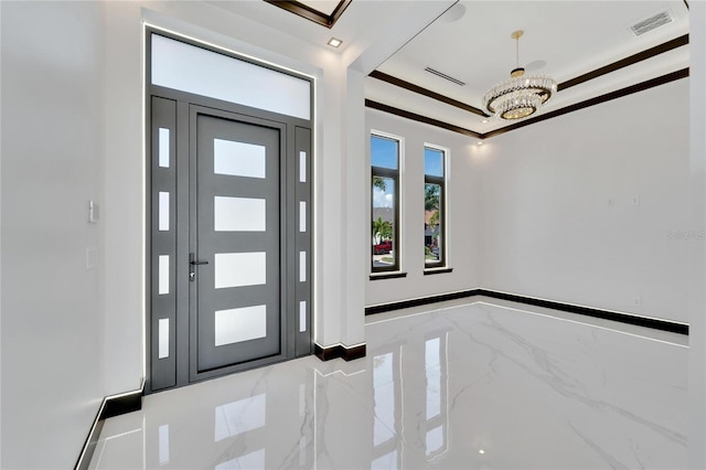 foyer entrance with a chandelier