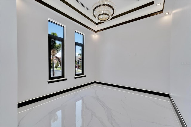 spare room featuring an inviting chandelier and ornamental molding