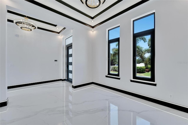 unfurnished room featuring an inviting chandelier and ornamental molding