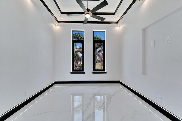 spare room featuring ceiling fan, ornamental molding, and a raised ceiling