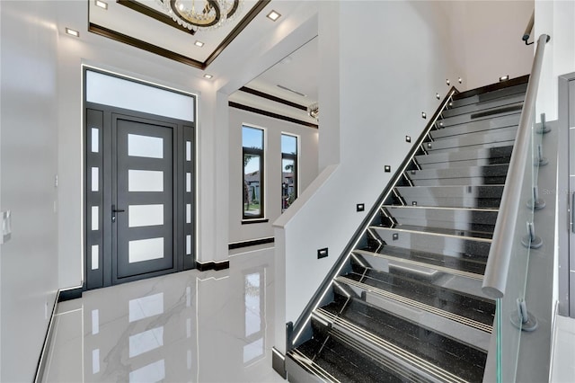 foyer entrance featuring crown molding