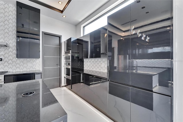 kitchen with decorative backsplash and dark stone counters