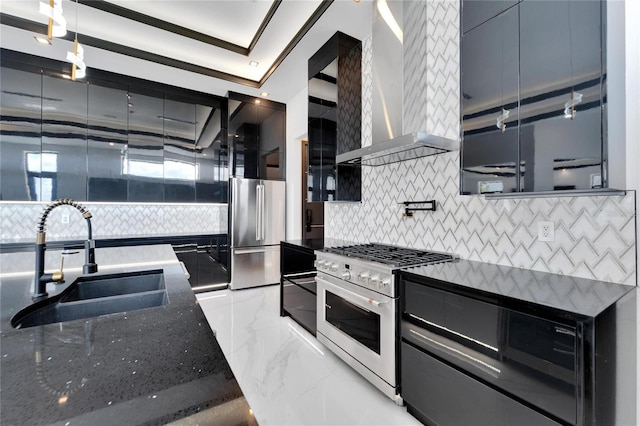 kitchen with premium appliances, wall chimney range hood, dark stone counters, sink, and ornamental molding