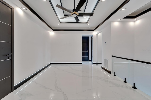 unfurnished room with ceiling fan, a tray ceiling, and ornamental molding