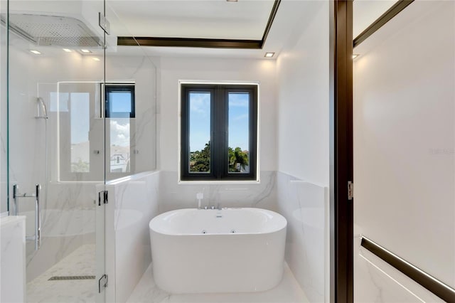 bathroom featuring tile walls and shower with separate bathtub