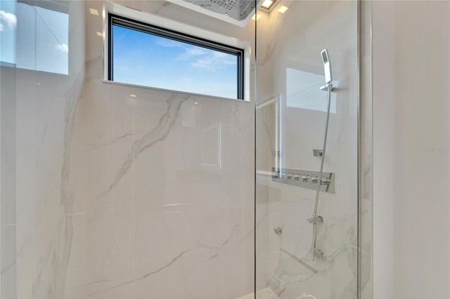 bathroom with a tile shower