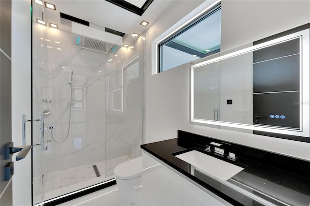 bathroom with a shower with door, toilet, and vanity