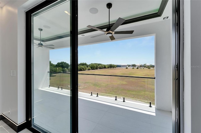 doorway to outside featuring ceiling fan and tile patterned floors